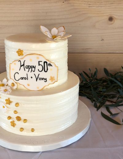 50th anniversary cake with buttercream and small gold flowers