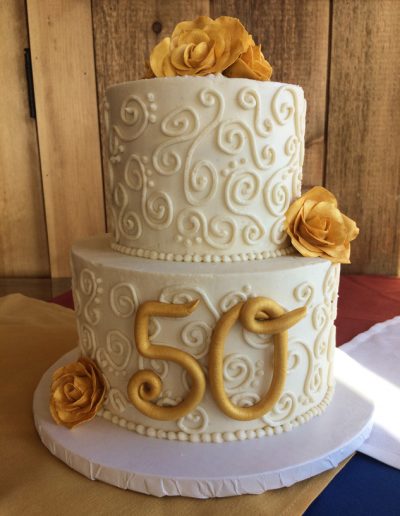 50th anniversary cake with piping and gold flowers
