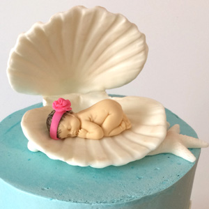 baby shower cake with baby in shell
