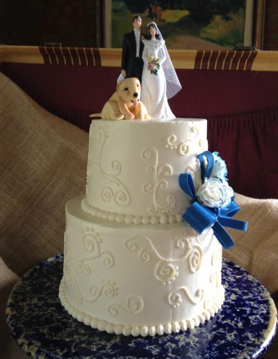 buttercream wedding cake with couple topper and fondant dog