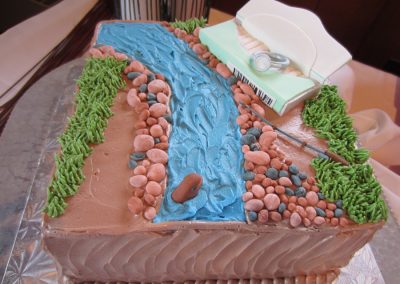 grooms cake with stream scene and ring in Trident box