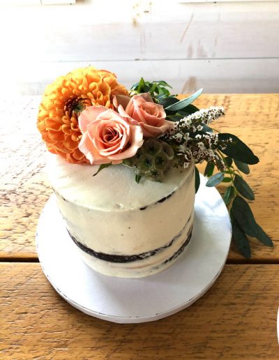 seminaked elopement cake with bright flowers