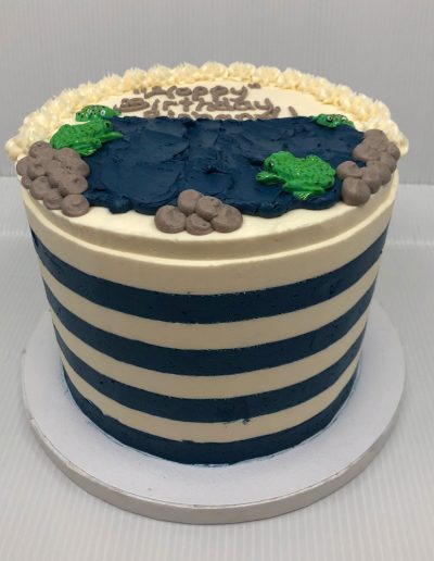 striped cake on sides with pond and frogs
