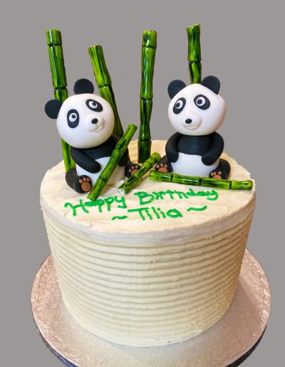 fondant pandas and bamboo on cake