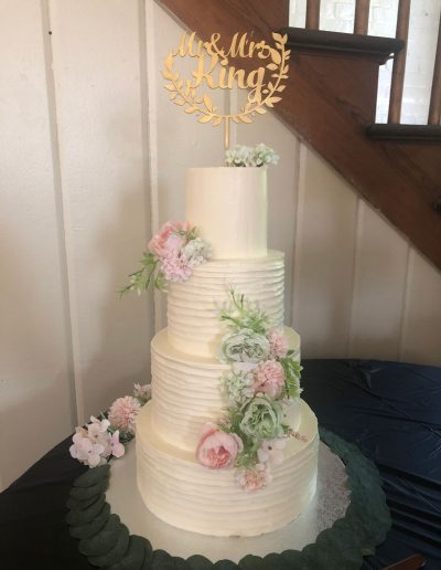 4-tier wedding cake with silk flowers