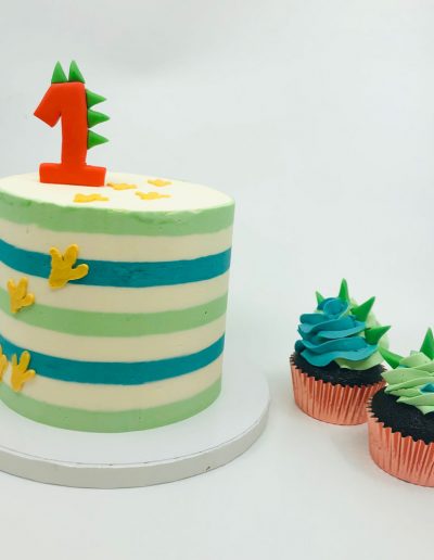 dinosaur-themed smash cake and cupcakes