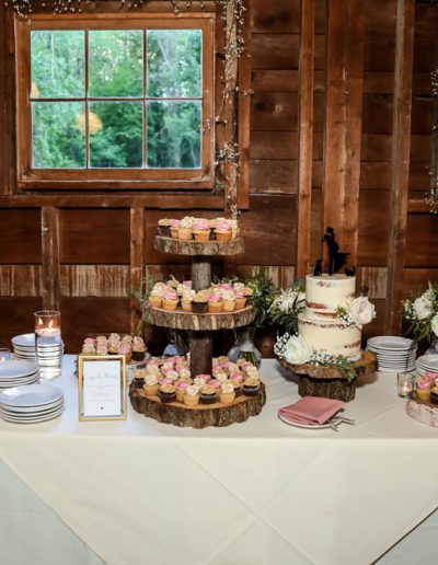 seminaked wedding cake and cupcakes on wooden stands