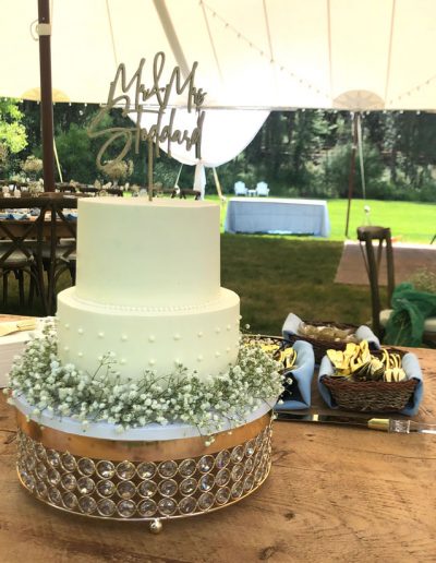 2-tier wedding cake decorated with baby's breath around its base