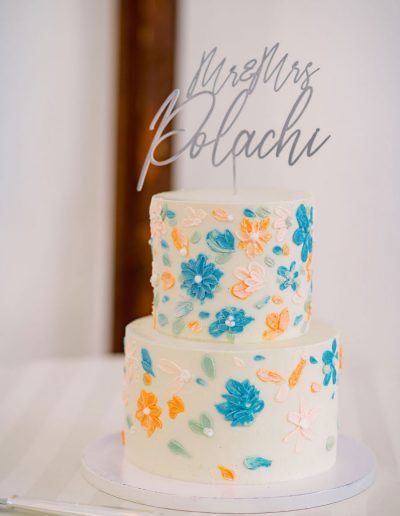 2-tier wedding cake with colorful palette flowers