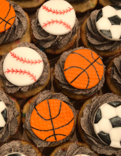 cupcakes with fondant baseball, soccer ball, and basketball toppers